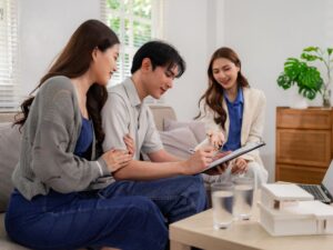 Young Australian couple discussing their home options with a buyer’s agent.